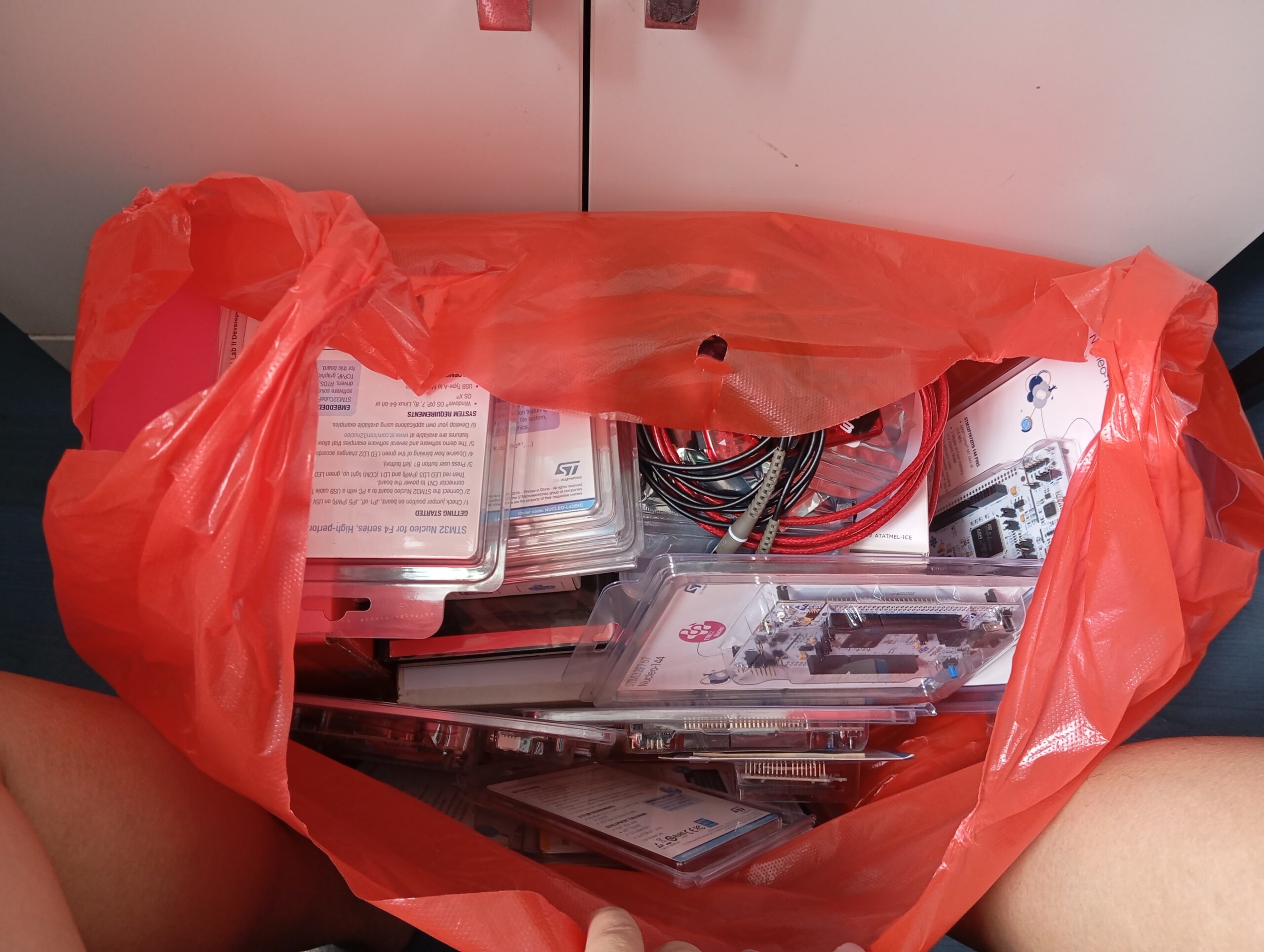 A photo of the electronics dev boards that are filling up the plastic bag.