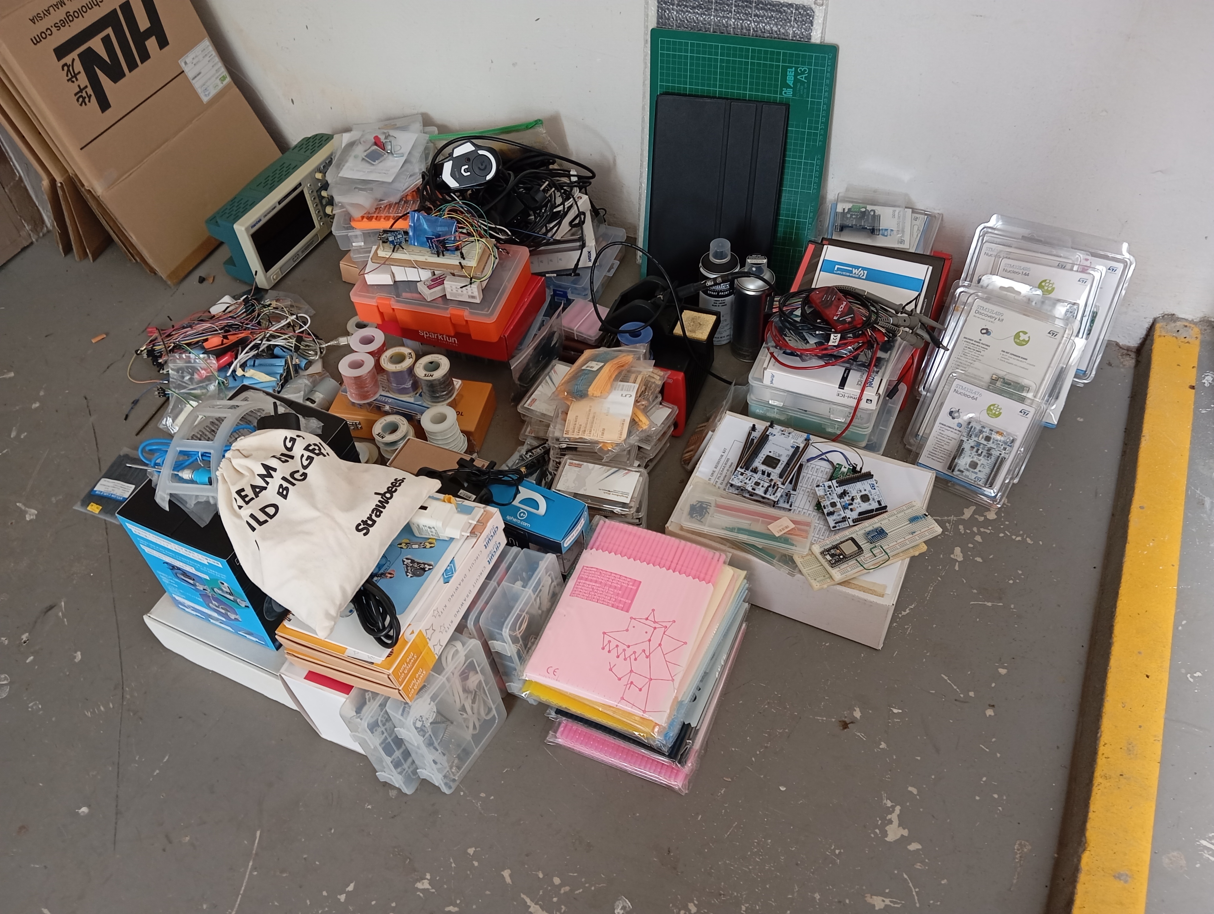 A photo of all the electronics and STEAM kits that I've placed in this spot at the void deck of our HDB apartment block.